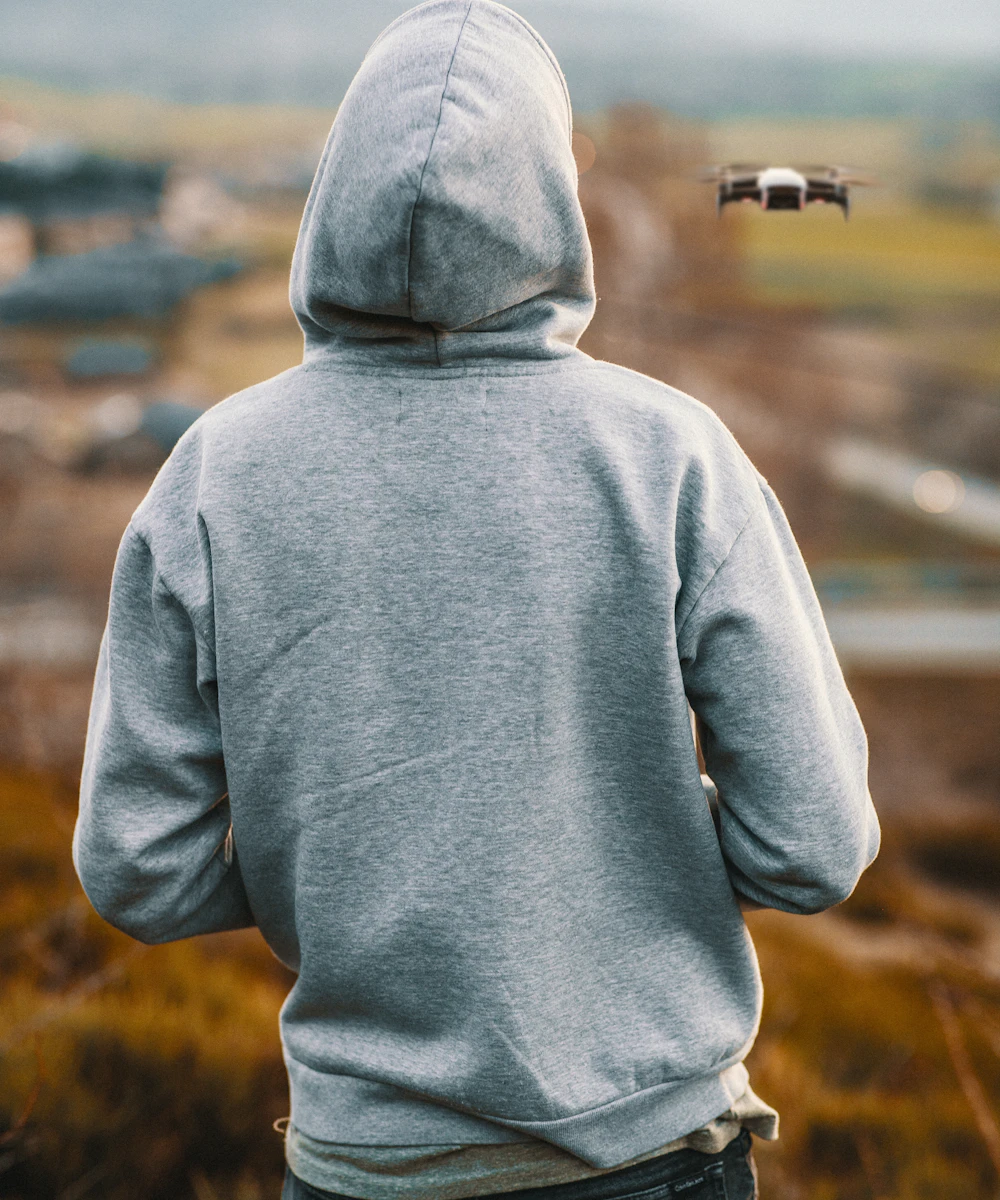 Person in a grey heavyweight hoodie, seen from behind