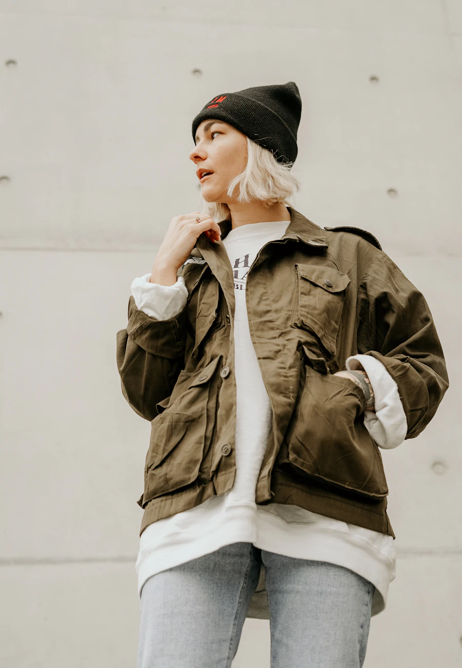 Woman in a khaki utility jacket and beanie